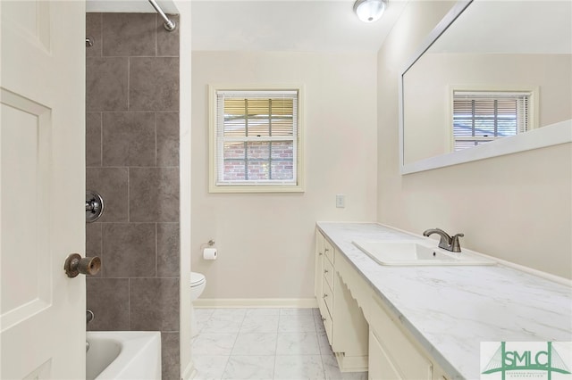 full bathroom featuring a healthy amount of sunlight, vanity, tiled shower / bath combo, and toilet