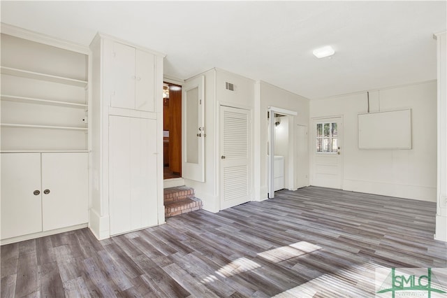 empty room with washer and dryer and hardwood / wood-style floors