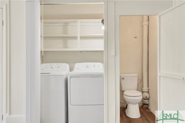 laundry area featuring wood-type flooring and separate washer and dryer