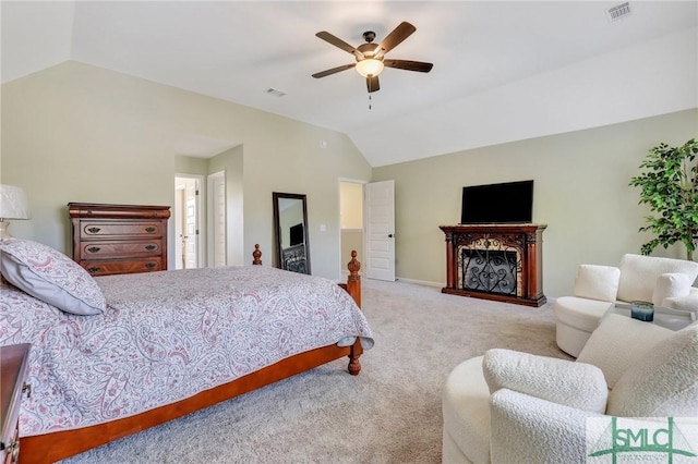 bedroom featuring carpet, a fireplace, lofted ceiling, visible vents, and ceiling fan