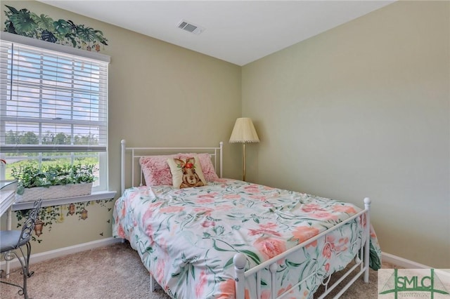 carpeted bedroom featuring visible vents and baseboards