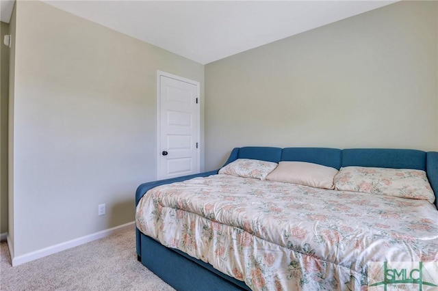 bedroom with carpet and baseboards