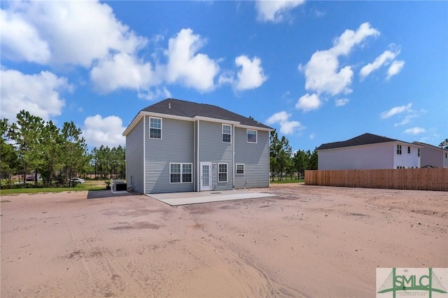 back of property featuring cooling unit, fence, and a patio