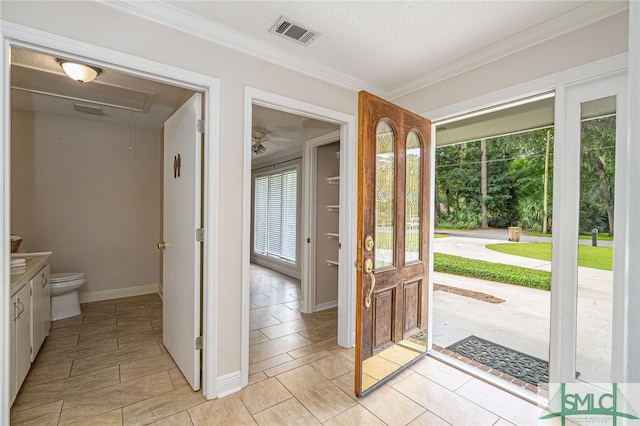 entryway featuring crown molding and a textured ceiling