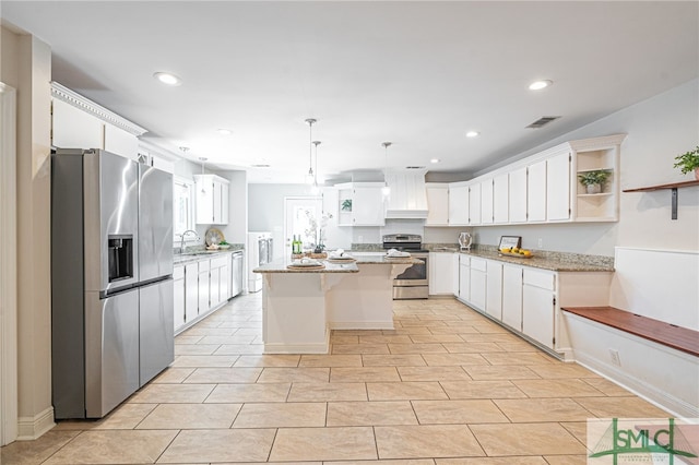 kitchen with sink, decorative light fixtures, a center island, stainless steel appliances, and white cabinets