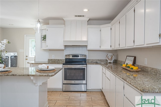 kitchen with white cabinetry, stainless steel electric range oven, washer / clothes dryer, and light stone countertops