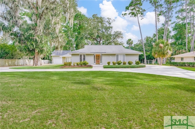 ranch-style home with a garage and a front lawn