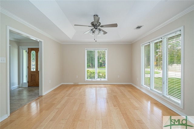 empty room with crown molding, ceiling fan, and light wood-type flooring