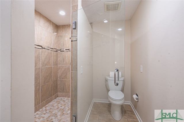 bathroom with tile patterned floors, a shower with door, and toilet