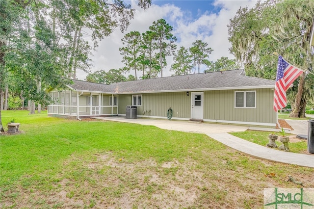 back of property featuring a sunroom, cooling unit, a patio area, and a lawn