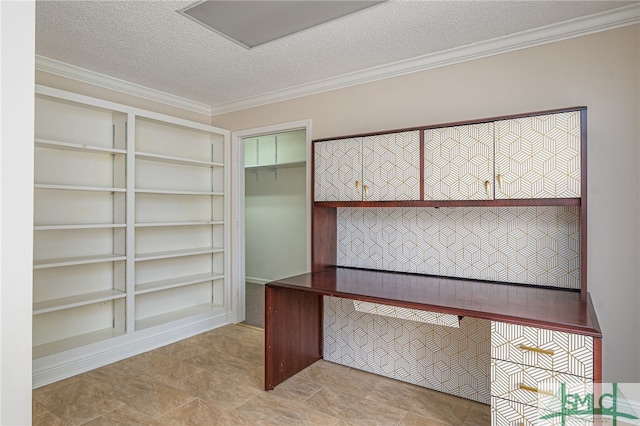 unfurnished office featuring crown molding and a textured ceiling