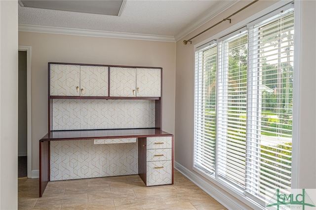 unfurnished office featuring ornamental molding and a textured ceiling