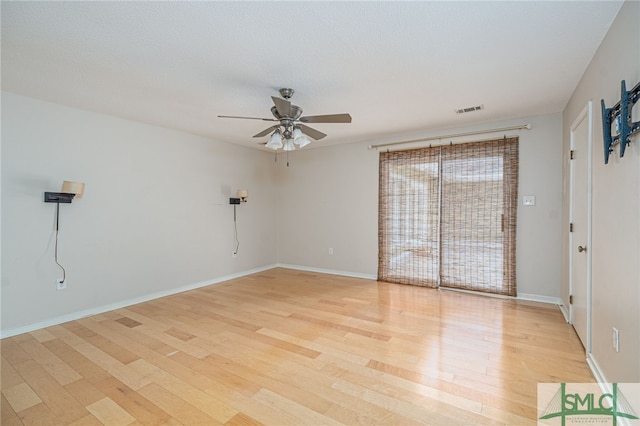 unfurnished room featuring ceiling fan, light hardwood / wood-style floors, and a textured ceiling