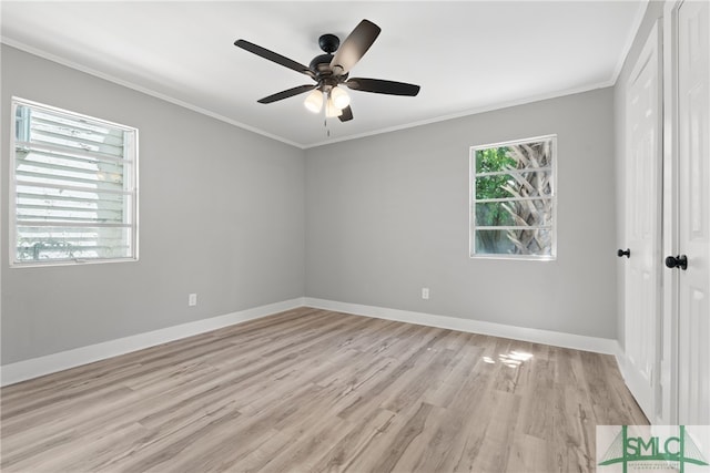 spare room featuring light hardwood / wood-style floors, crown molding, and ceiling fan