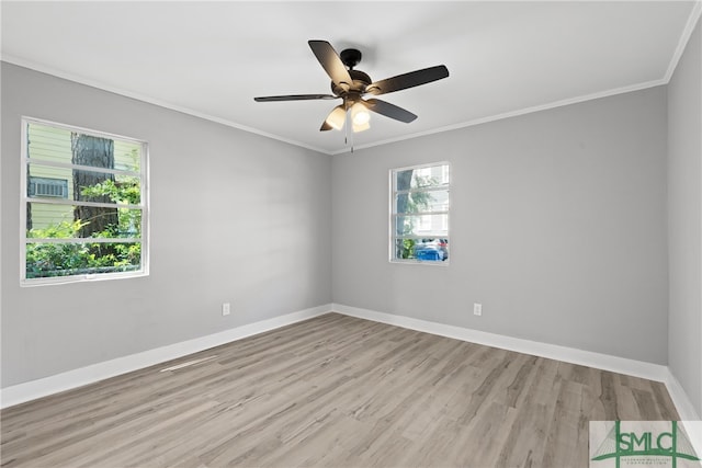 empty room with ceiling fan, light hardwood / wood-style flooring, and crown molding