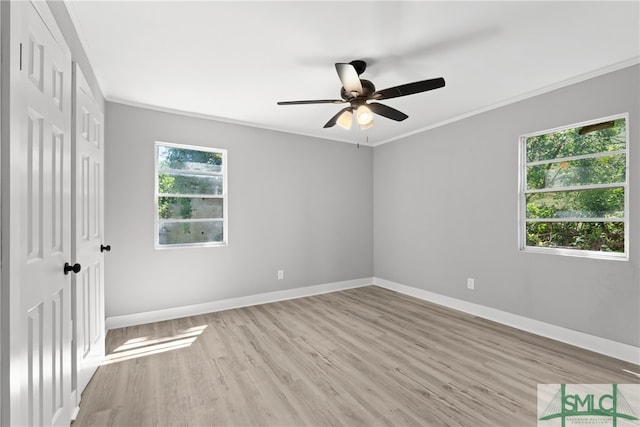 spare room with a wealth of natural light, light hardwood / wood-style flooring, and ceiling fan