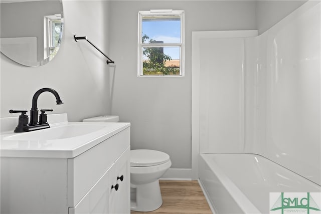 full bathroom with bathtub / shower combination, vanity, hardwood / wood-style floors, and toilet