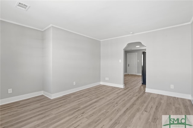 unfurnished room with light wood-type flooring and ornamental molding