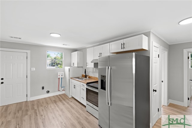 kitchen featuring sink, stainless steel appliances, white cabinetry, and light hardwood / wood-style flooring