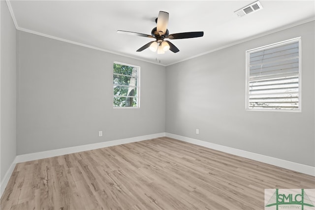 empty room featuring hardwood / wood-style floors, crown molding, and ceiling fan