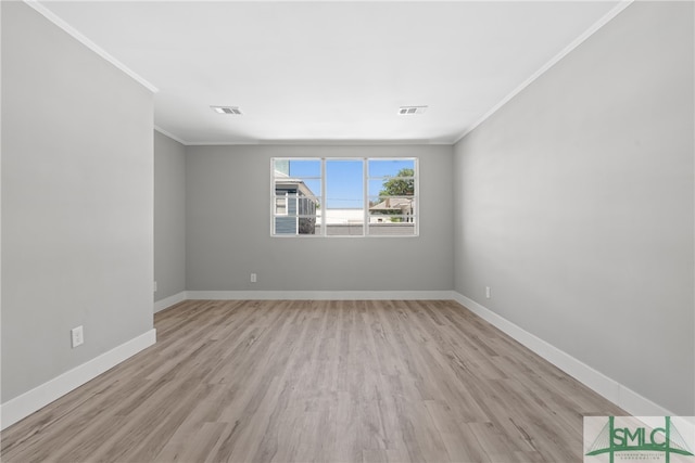 unfurnished room featuring light wood-type flooring and crown molding