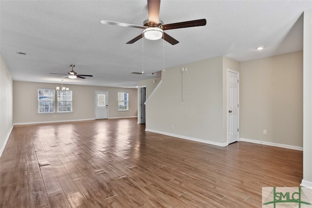 unfurnished living room featuring wood-type flooring, a textured ceiling, and ceiling fan