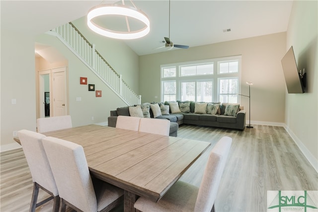 dining room with ceiling fan and light hardwood / wood-style floors