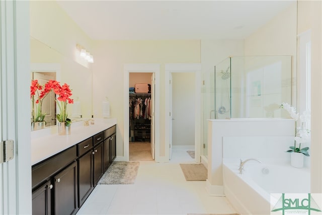 bathroom featuring tile patterned floors, independent shower and bath, and vanity