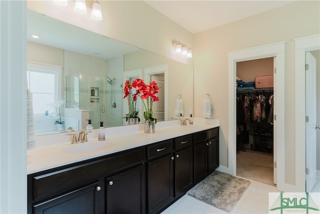 bathroom with tile patterned flooring, vanity, and walk in shower