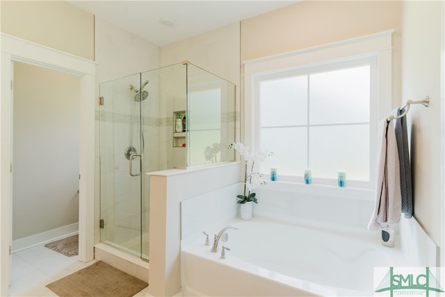 bathroom with tile patterned flooring, separate shower and tub, and a healthy amount of sunlight