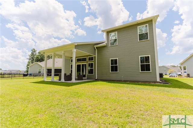 back of house with a patio area and a yard