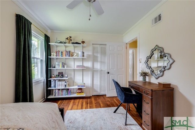 office area with ornamental molding, wood-type flooring, and ceiling fan