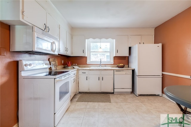 kitchen featuring white cabinetry, white appliances, light tile patterned floors, and sink