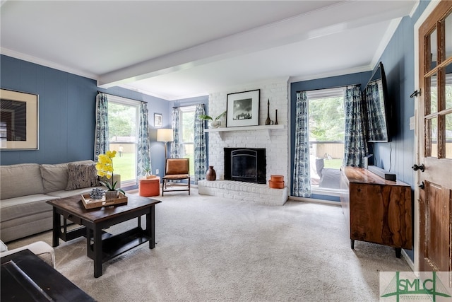 carpeted living room with crown molding, plenty of natural light, a brick fireplace, and beam ceiling