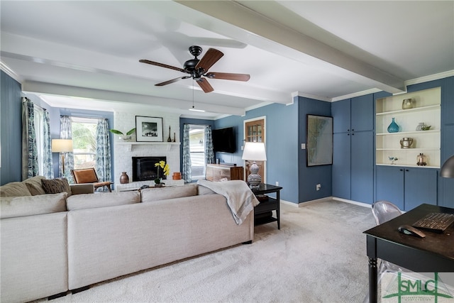 carpeted living room featuring crown molding, ceiling fan, beam ceiling, and a fireplace