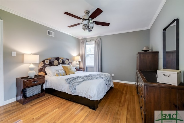 bedroom featuring crown molding, hardwood / wood-style flooring, and ceiling fan