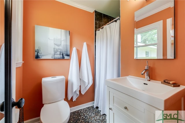 bathroom with tile patterned flooring, vanity, toilet, and ornamental molding