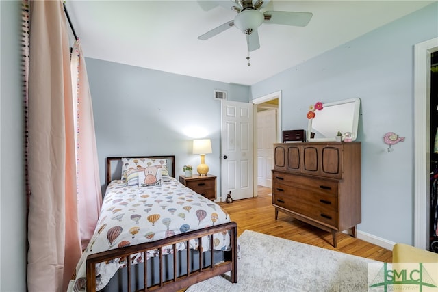 bedroom with ceiling fan and light hardwood / wood-style floors