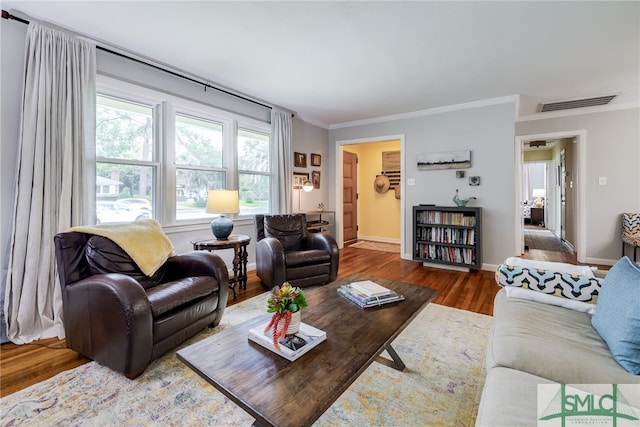 living room with ornamental molding and hardwood / wood-style flooring