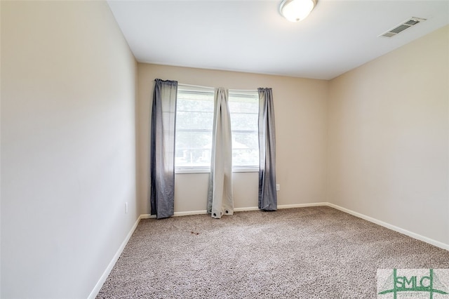 unfurnished room featuring carpet