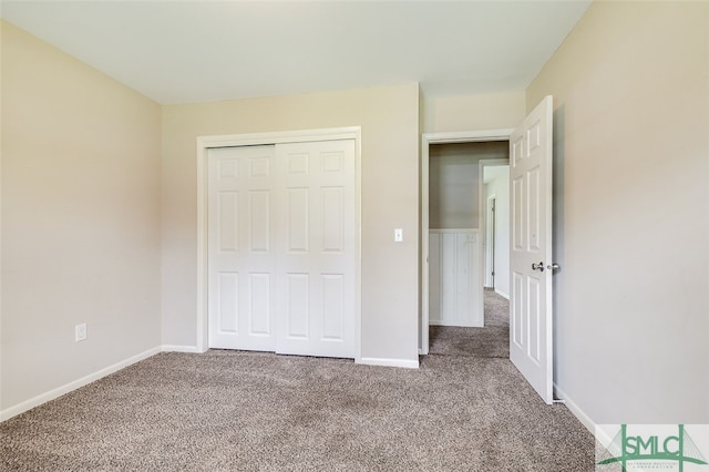 unfurnished bedroom featuring a closet and carpet floors