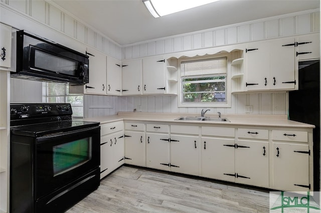 kitchen featuring sink, black appliances, light hardwood / wood-style floors, and white cabinets