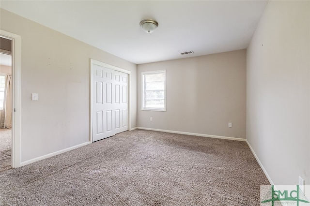 unfurnished bedroom with a closet and carpet