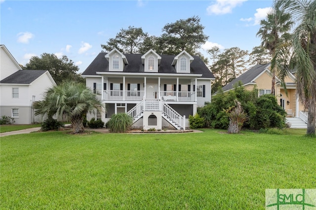 rear view of property featuring a porch and a yard