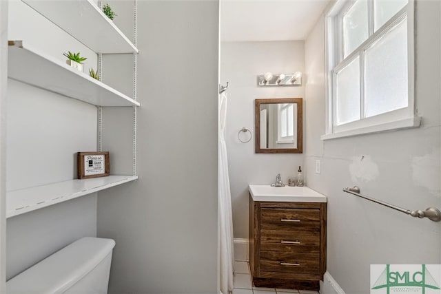 bathroom featuring vanity, toilet, and tile patterned floors