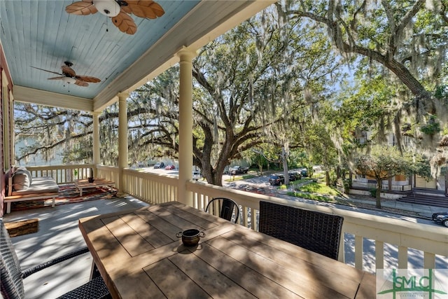 wooden deck featuring ceiling fan