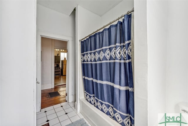 bathroom with shower / bath combo and tile patterned flooring