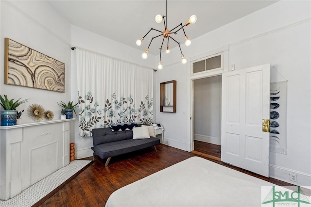 interior space featuring dark hardwood / wood-style flooring and an inviting chandelier