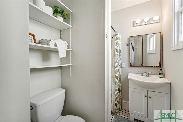 bathroom featuring curtained shower, vanity, toilet, and tile patterned floors