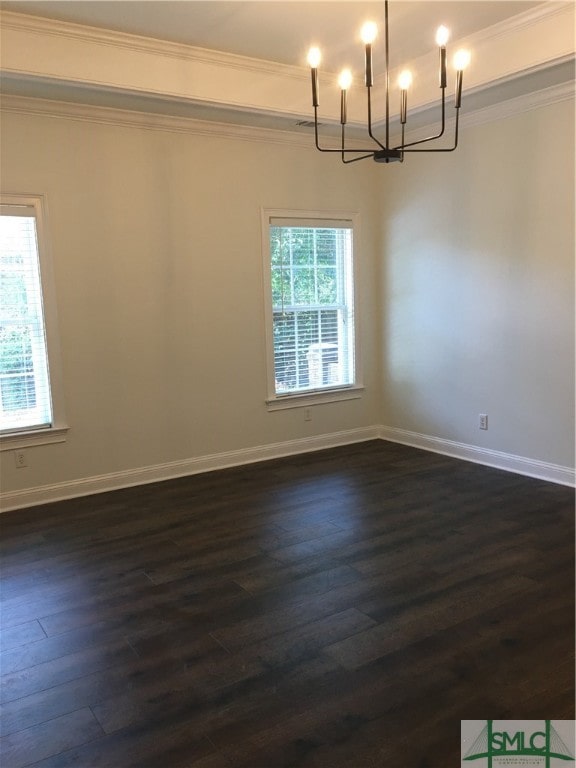 unfurnished room with crown molding, dark hardwood / wood-style floors, and an inviting chandelier